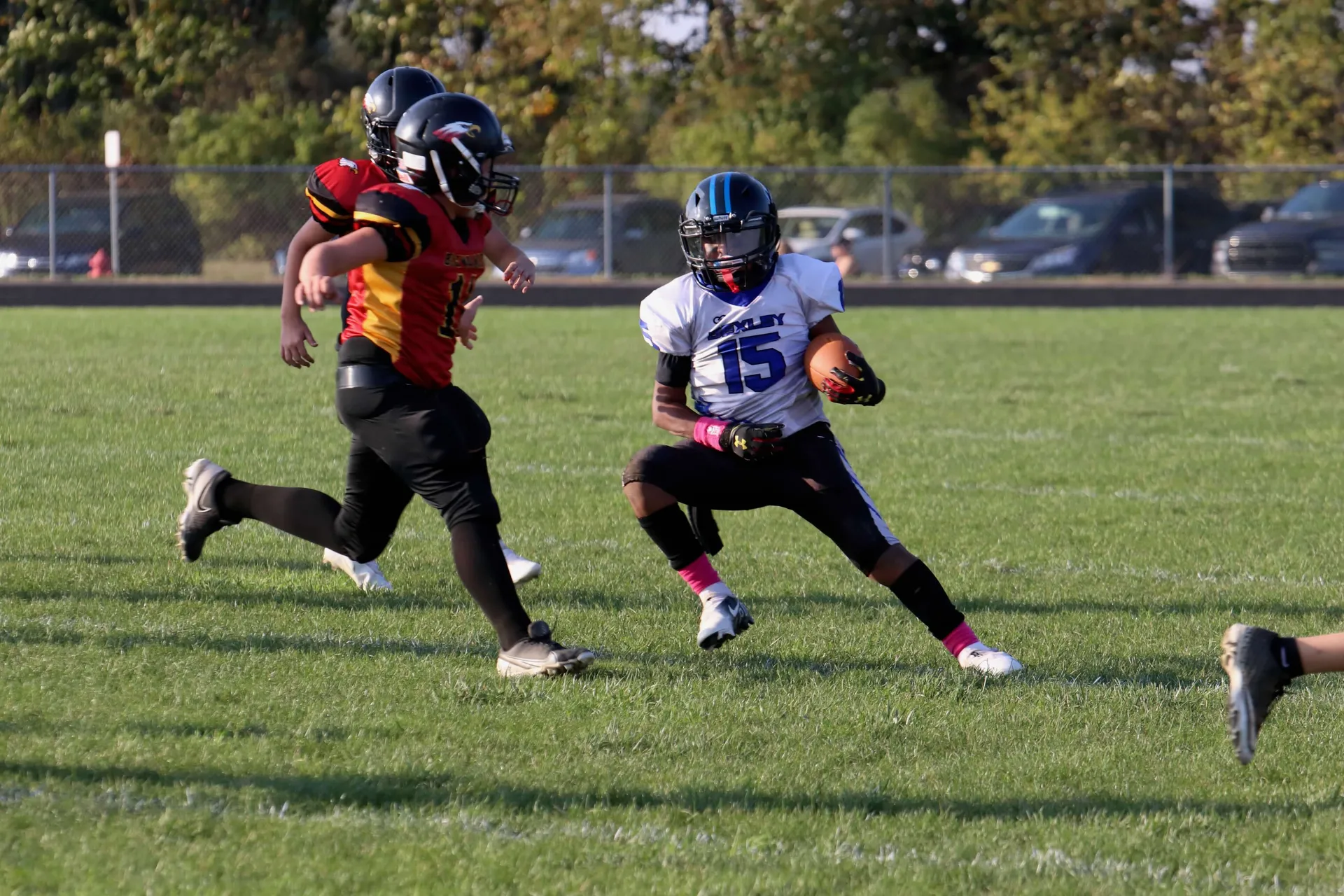 A Bexley ball carrier makes a cut in open grass, one-on-one with a defender.